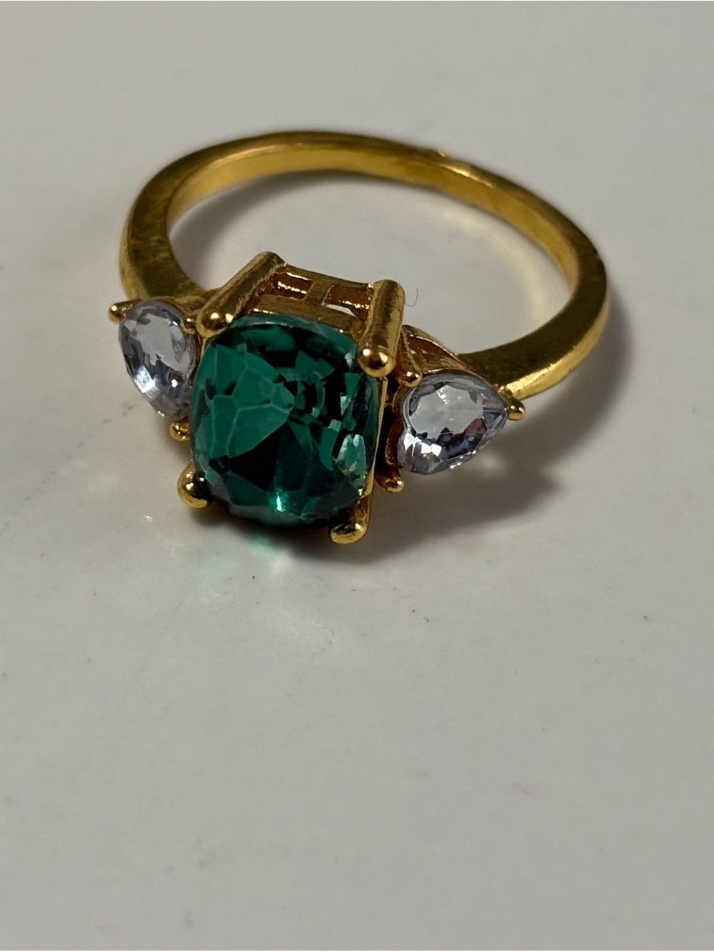 Gold-tone ring with Lab created Emerald and heart shaped Clear Side Stones
